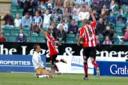 Instant hero: Chris Moore (background) celebrates after his late strike earned Brentford a draw at Brighton last Saturday to maintain their unbeaten start to the season. Simon Dack