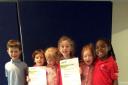 Pupils at Little Voices with their certificates of excellence