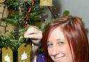 Holly Marshfield, Garden Centre Assistant, putting her memory on the tree.