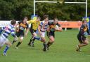 On the charge: Esher centre Aaron Cruickshanks makes a break with double try scorer Mike MacFarlane in hot pursuit