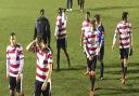 Picture tells the story: Kingstonian's players could have looked happier after reaching the Robert Dyas Cup final on Monday night