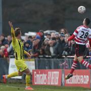 Kingstonian left-back Fabio Saraiva heads the ball at a sold-out King George's Field on Saturday. Pic: Simon Roe.