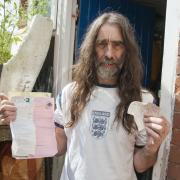 Mr Knowles with the parking ticket he bought and his correspondence with the council