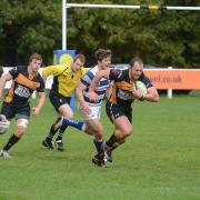 On the charge: Esher centre Aaron Cruickshanks makes a break with double try scorer Mike MacFarlane in hot pursuit