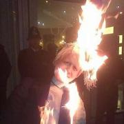 Jane Nicholl set fire to the effigy of Boris Johnson. Picture courtesy of Bindmans LLP