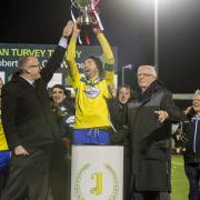 You beauty: Kingstonian skipper Alan Inns lifts the Alan Turvey Trophy