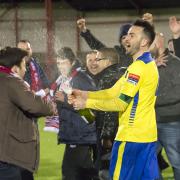 Good time in the gloom: Alan Inns celebrates lifting the Alan Turvey Trophy in an otherwise miserable last month of last season