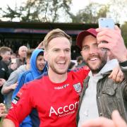 Memorable moment: Tom Jelley celebrated with a friend on the Beveree pitch after Hampton secured the Ryman  Premier League title in April