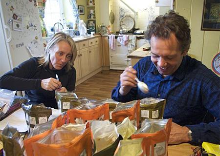 Ann Daniels and Pen Hadow taste the expedition food - dried meals to which they have to add hot water. Picture: Martin Hartley
