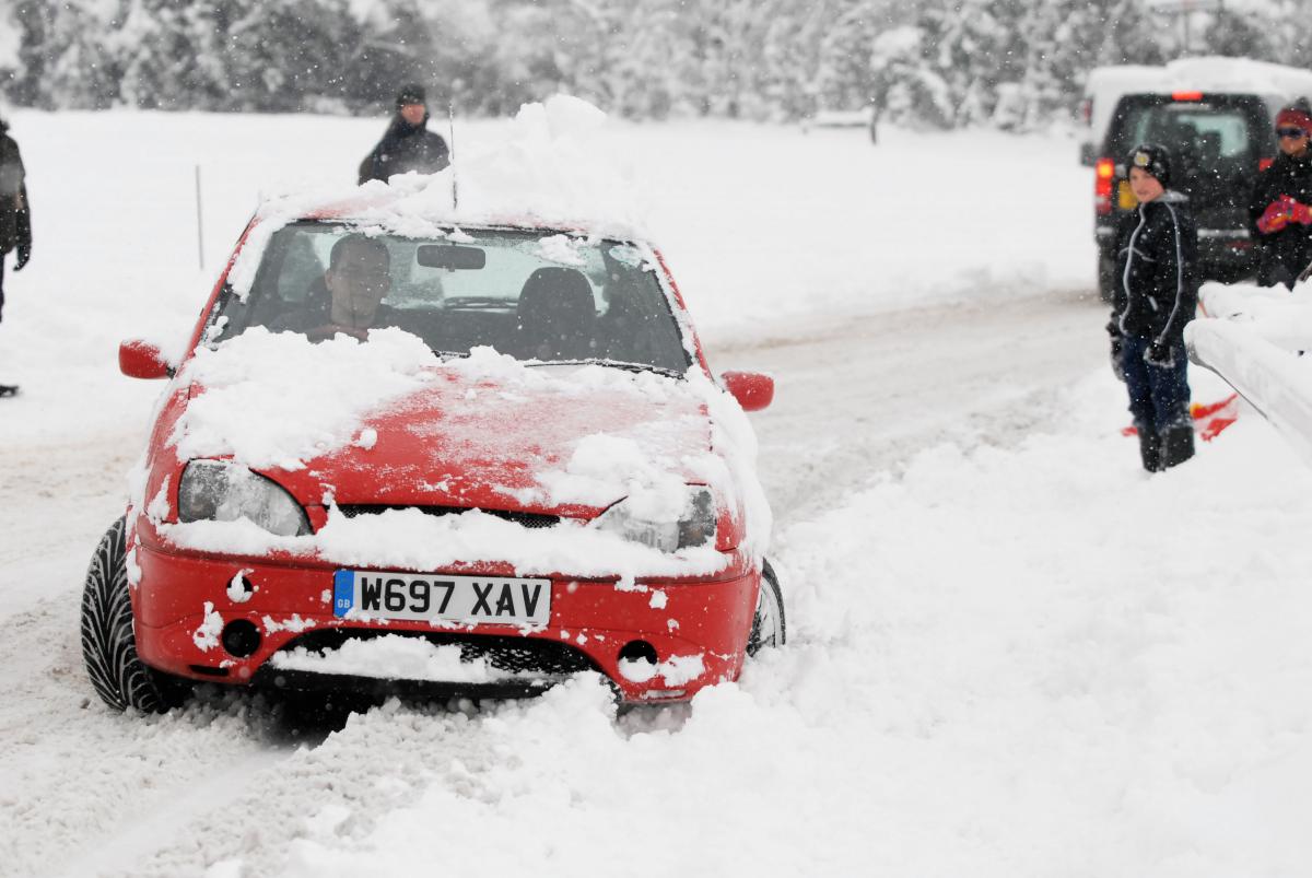 The snow rendered roads impassable, as this stranded motorist discovered on Epsom Downs. Picture:  Chris Gray