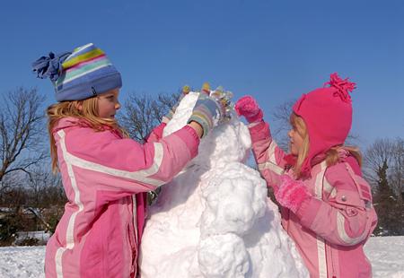 In Sutton, Amy and Emily Graham used their time off school to build a snowman. Picture: Gareth Harmer