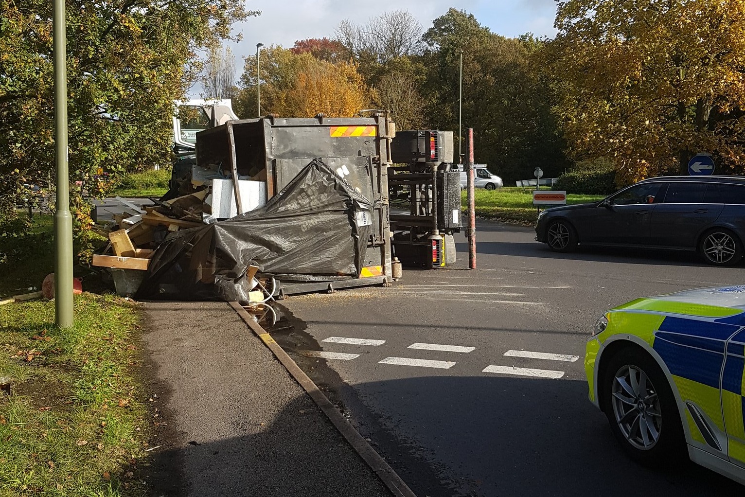 Fire and police teams work to clear overturned lorry in Esher