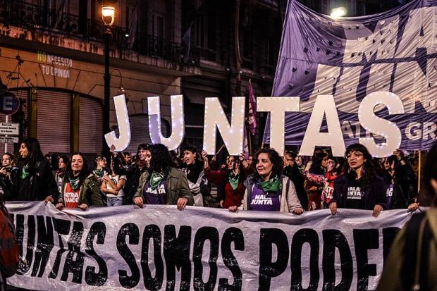Activists with the Ni Una Menos movement march in Buenos Aires, Argentina. The banner reads: 'Together we are powerful'. Image: TitiNicola
