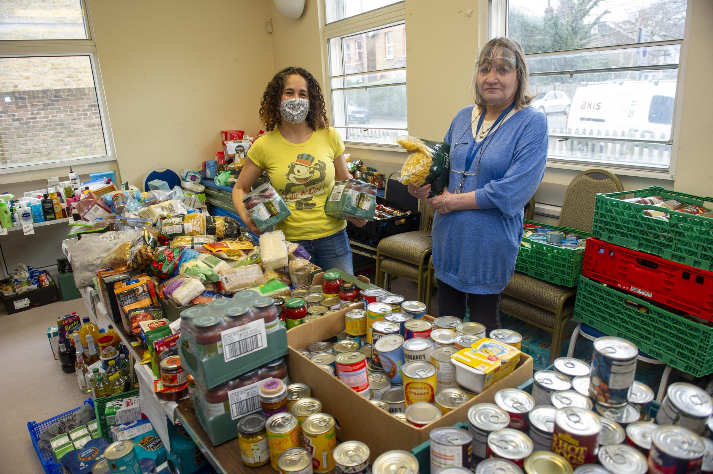 Piper Hall food bank feature with coordinator Jill Preston (Blue jumper/clear visor PPE) with helper Suzanne Seyghal.