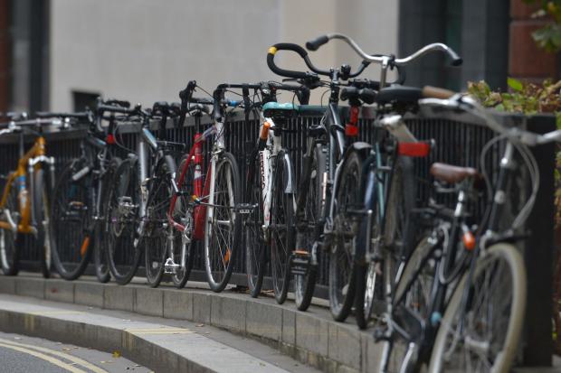 Bicycles left against railings in central London. Nick Ansell/PA Wire