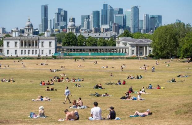 Your Local Guardian: People enjoy the sun in Greenwich. Picture: PA