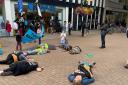 Activists with Extinction Rebellion in Croydon stage a 'die-in' protest outside Barclays on North End, Croydon. Image: Croydon XR