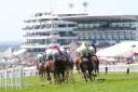 Runners and riders during the Racehorse Lotto Handicap during ladies day of the 2023 Derby Festival at Epsom Downs Racecourse