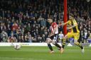 Dominant force: Bees striker Scott Hogan scores in a 3-0 win over Fulham at Griffin Park last season
