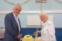 Councillor Stephen Alambritis with resident, Jean Marshall, cutting the cake