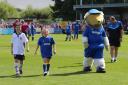 Special one: Amy Hurry, centre, enjoys her moment in the limelight with Haydon the Womble                               Picture: Stuart Butcher / Pro Sports Images