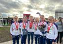 Hercules Wimbledon’s Ellen Weir second from the right holding the flowers with the bronze medal-winning British team