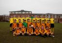 Seeing double: Hampton Schools U18 footballers, in yellow, line up with their U15 schoolmates