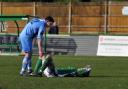 Down and out: Kingstonian's Bobby Traynor consoles Leatherhead's Harry Ottaway after relegation