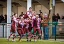 Late drama: Corinthian Casuals midfielder Dave Hodges, right, is mobbed after his stoppage time winner on Saturday 	Stuart Tree