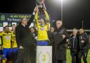 You beauty: Kingstonian skipper Alan Inns lifts the Alan Turvey Trophy