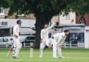Spin king: Don Manuwelge, centre, claimed five wickets against Ealing on Saturday