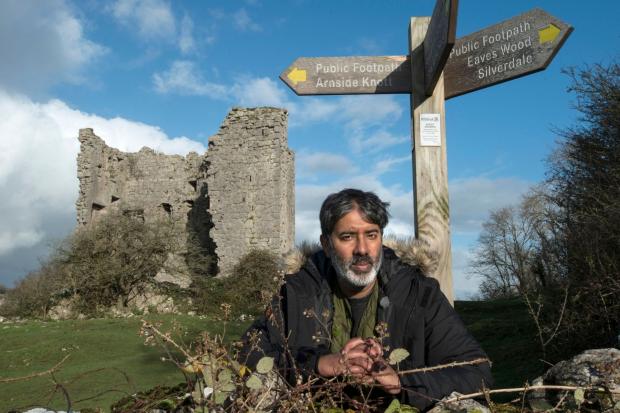 Your Local Guardian: Nihal Arthanayake under a footpath sign next to Arnside Tower. Photo credit: BBC.