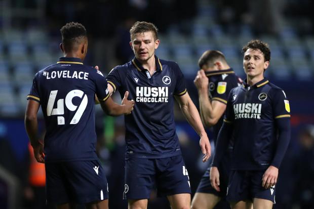 Millwall's Shaun Hutchinson (centre) and Zak Lovelace (left) shake hands after victory in the Sky Bet Championship match at the Coventry Building Society Arena, Coventry.
