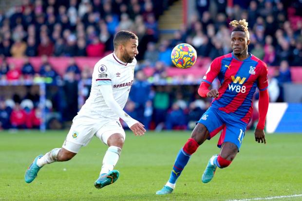 Burnley's Aaron Lennon (left) and Crystal Palace's Wilfried Zaha battle for the ball during the Premier League match at Selhurst Park, London.
