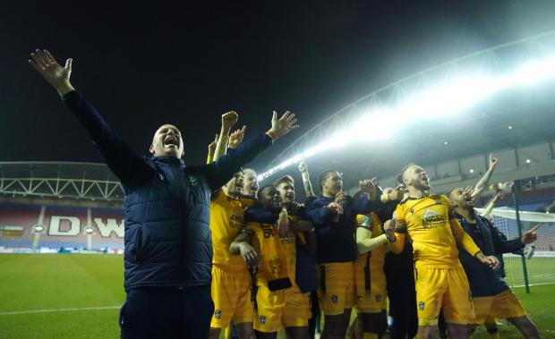 Your Local Guardian: Sutton United manager Matt Gray celebrates with his players after winning the penalty shoot -out during the Papa John's Trophy semi final match at the DW Stadium, Wigan