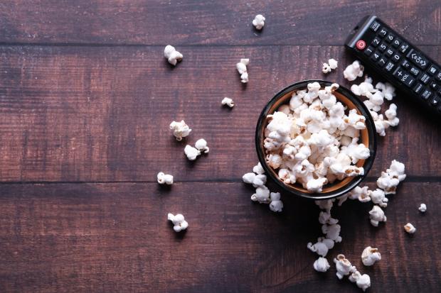 Your Local Guardian: A bowl of popcorn and a TV remote (Canva)