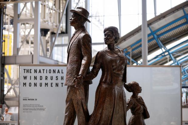 Your Local Guardian: The National Windrush Monument at Waterloo Station. The statue - of a man, woman and child in their Sunday best standing on top of suitcases - was designed by the Jamaican artist and sculptor Basil Watson