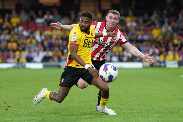 Watford's Emmanuel Dennis and Sheffield United's John Fleck (right) battle for the ball. Picture: PA Wire/PA Images.