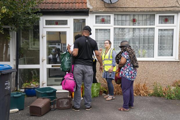 A council worker issues advice to residents returning to their homes in Galpin's Road in Thornton Heath (photo: PA)