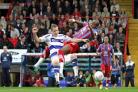 Staying put: Anthony Gardner gets in a tangle with QPR's Heidar Helguson