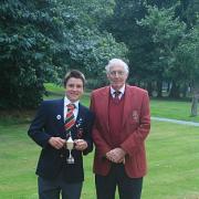 Champion: David Boote receives the Surrey Junior Masters trophy from Surrey Golf Union president Martin Christmas