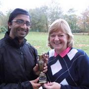 Vickesh Chauhan presents the winner’s trophy to Caroline Michel