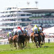 Runners and riders during the Racehorse Lotto Handicap during ladies day of the 2023 Derby Festival at Epsom Downs Racecourse