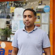 Moshin Akbary poses in front of MailSmart in St George's Walk in Croydon (photo: Facundo Arrizabalaga/MyLondon)