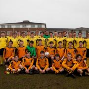 Seeing double: Hampton Schools U18 footballers, in yellow, line up with their U15 schoolmates