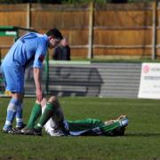 Down and out: Kingstonian's Bobby Traynor consoles Leatherhead's Harry Ottaway after relegation