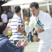 Tennis clinic: Former British number one Tim Henman takes time out to put youngsters through their paces at Sutton Tennis & Squash Club