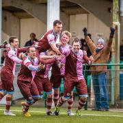 Late drama: Corinthian Casuals midfielder Dave Hodges, right, is mobbed after his stoppage time winner on Saturday 	Stuart Tree