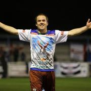Suits you: Jamie Byatt celebrates his hat-trick by showing off the shirt he was given by children during Corinthian Casuals' historic tour to Sao Paulo in Brazil earlier this year