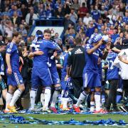 Happy days: Chelsea players celebrate victory over Crystal Palace, and the small matter of the Premier League title